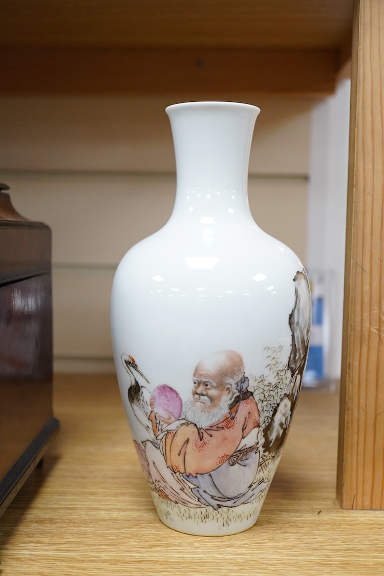 A Chinese famille rose vase, decorated with Shou Lao and script, 23cm